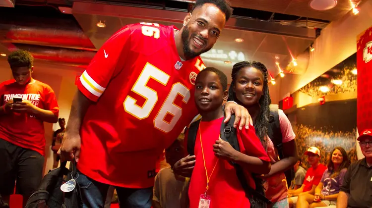 Texas Ex Derrick Johnson with students