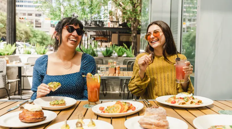 Two people enjoying brunch at Caroline Restaurant in Austin, Texas